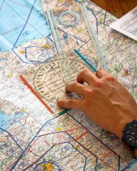 Person using a map and ruler during a workshop on power and policy.