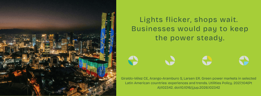 City skyline at night with illuminated skyscrapers and colorful lights.